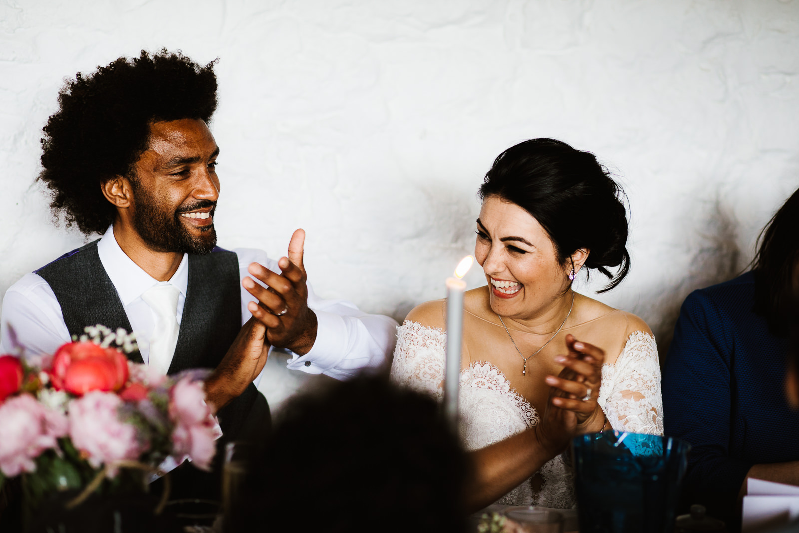 bride and groom laughing during speeches
