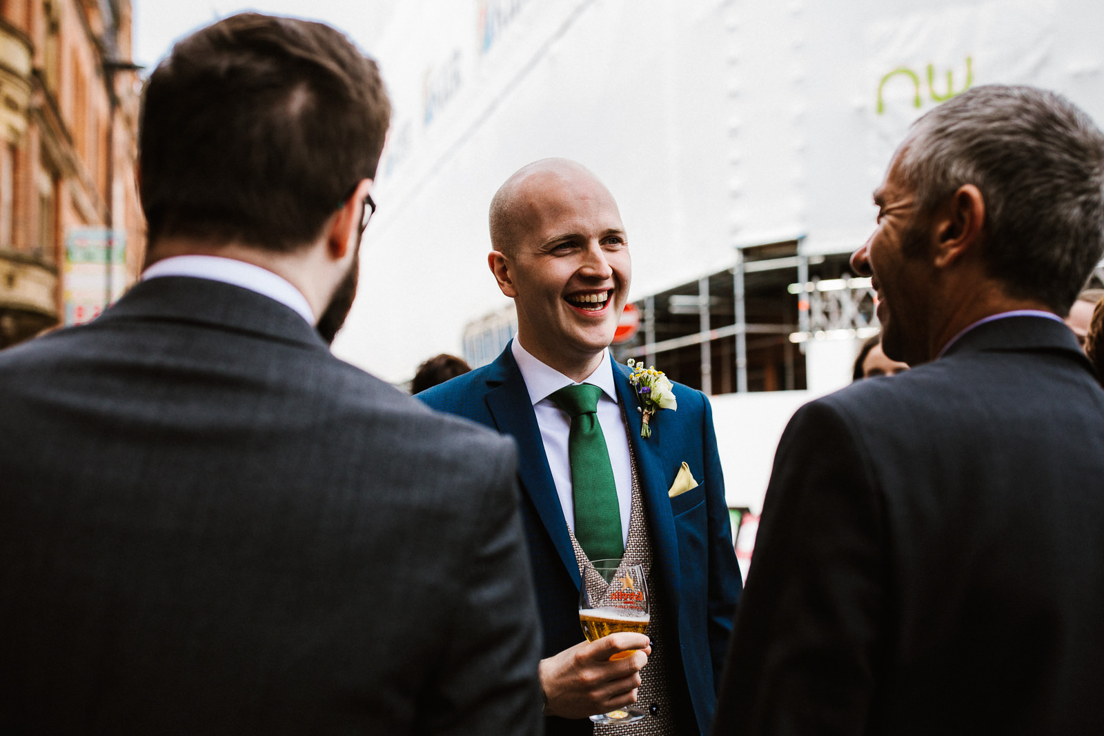 Groom laughing with friends