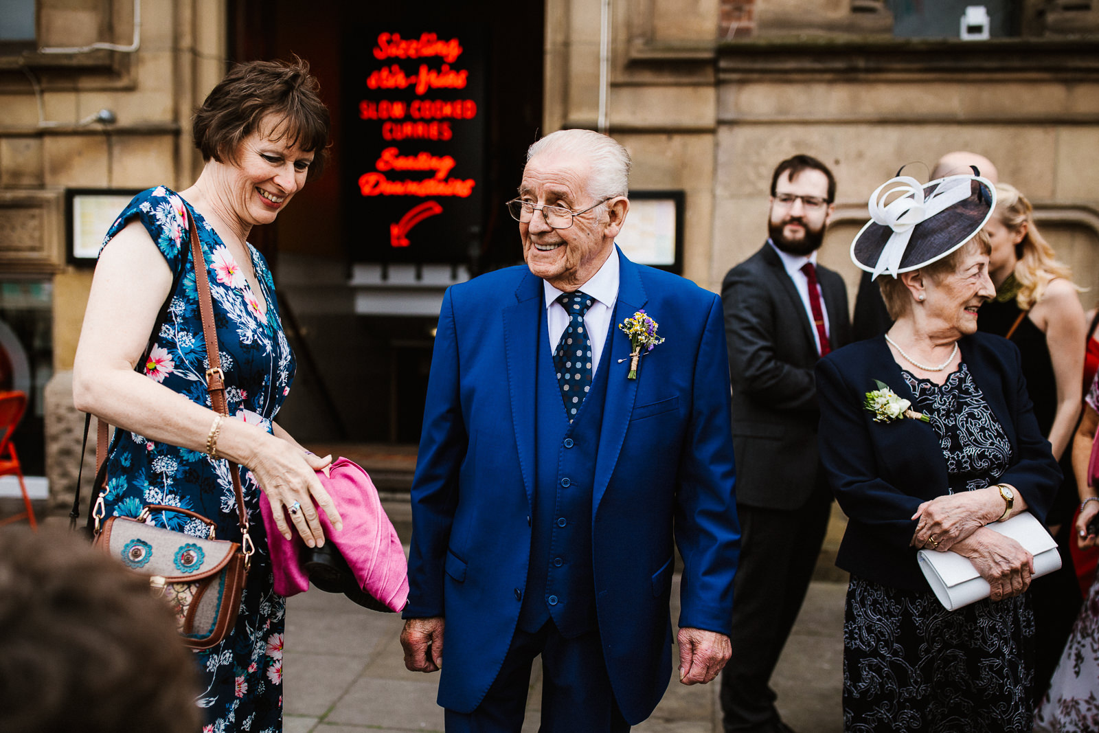 Grandad stands with guests