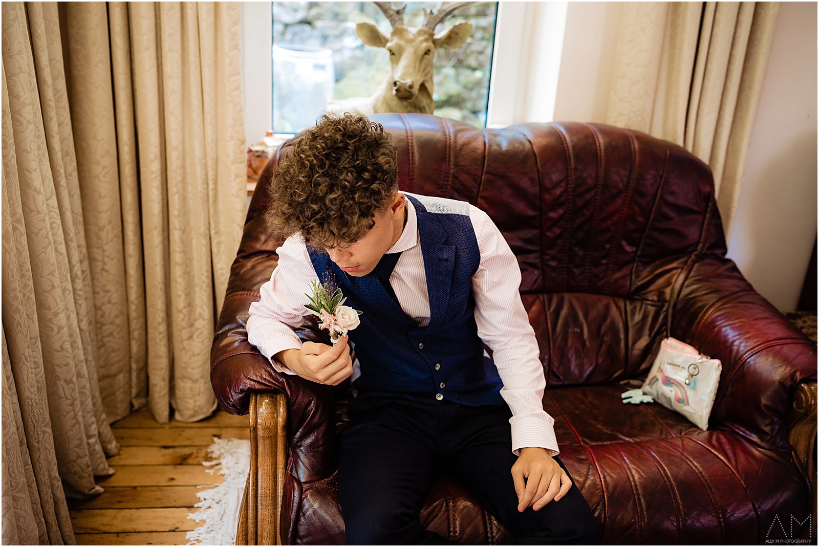 Brides son smelling flower