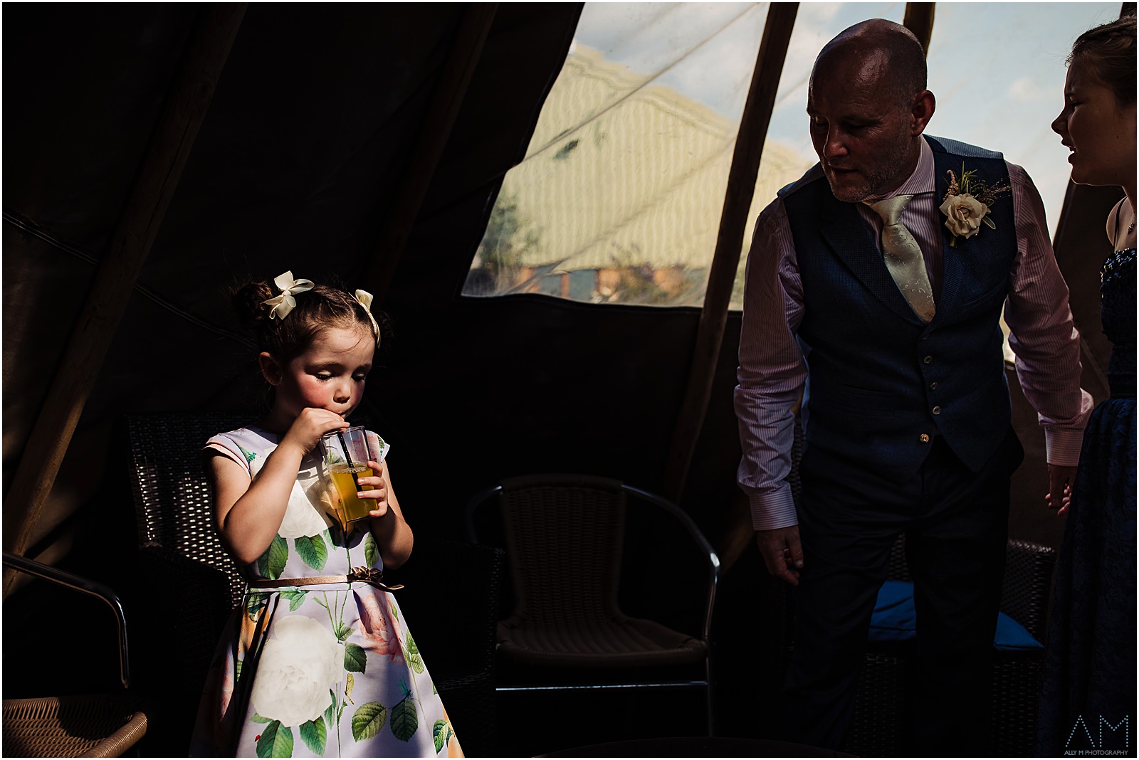 little girl having a drink in the tent