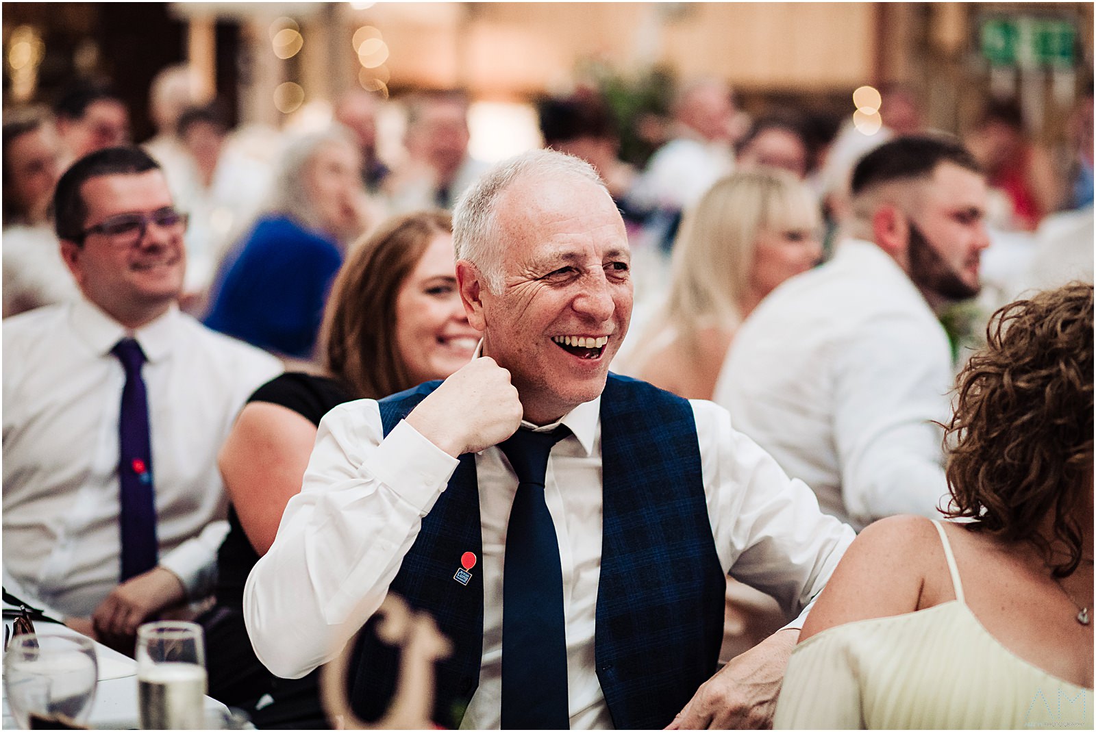 wedding guest laughing during speeches