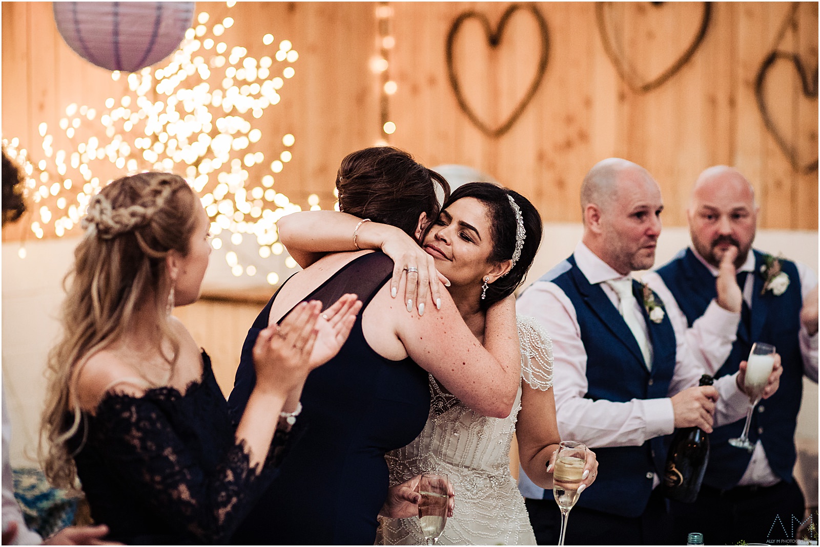 Bride hugging her bridesmaid