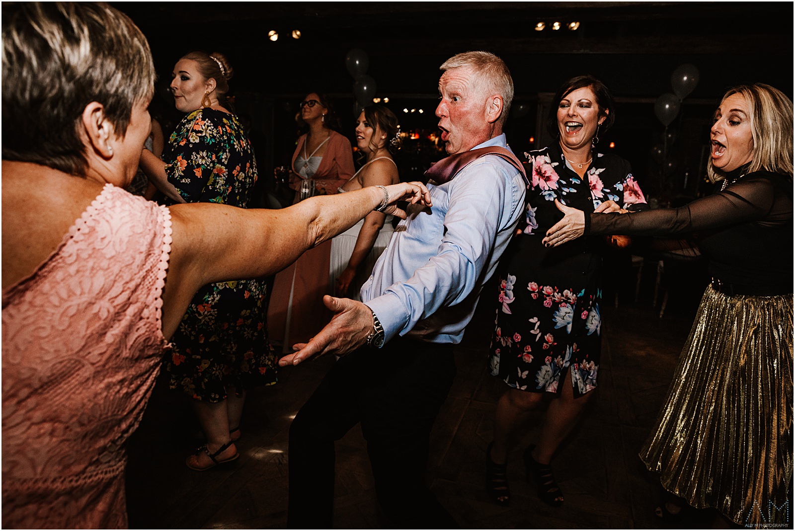Dragging wedding guest by his tie