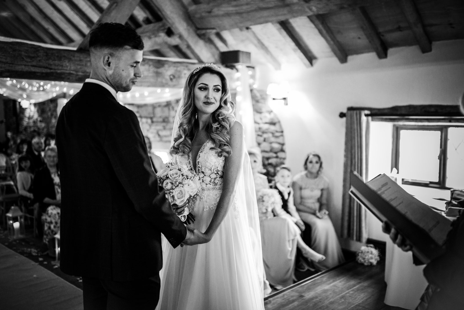 Bride and groom holding hands during the ceremony
