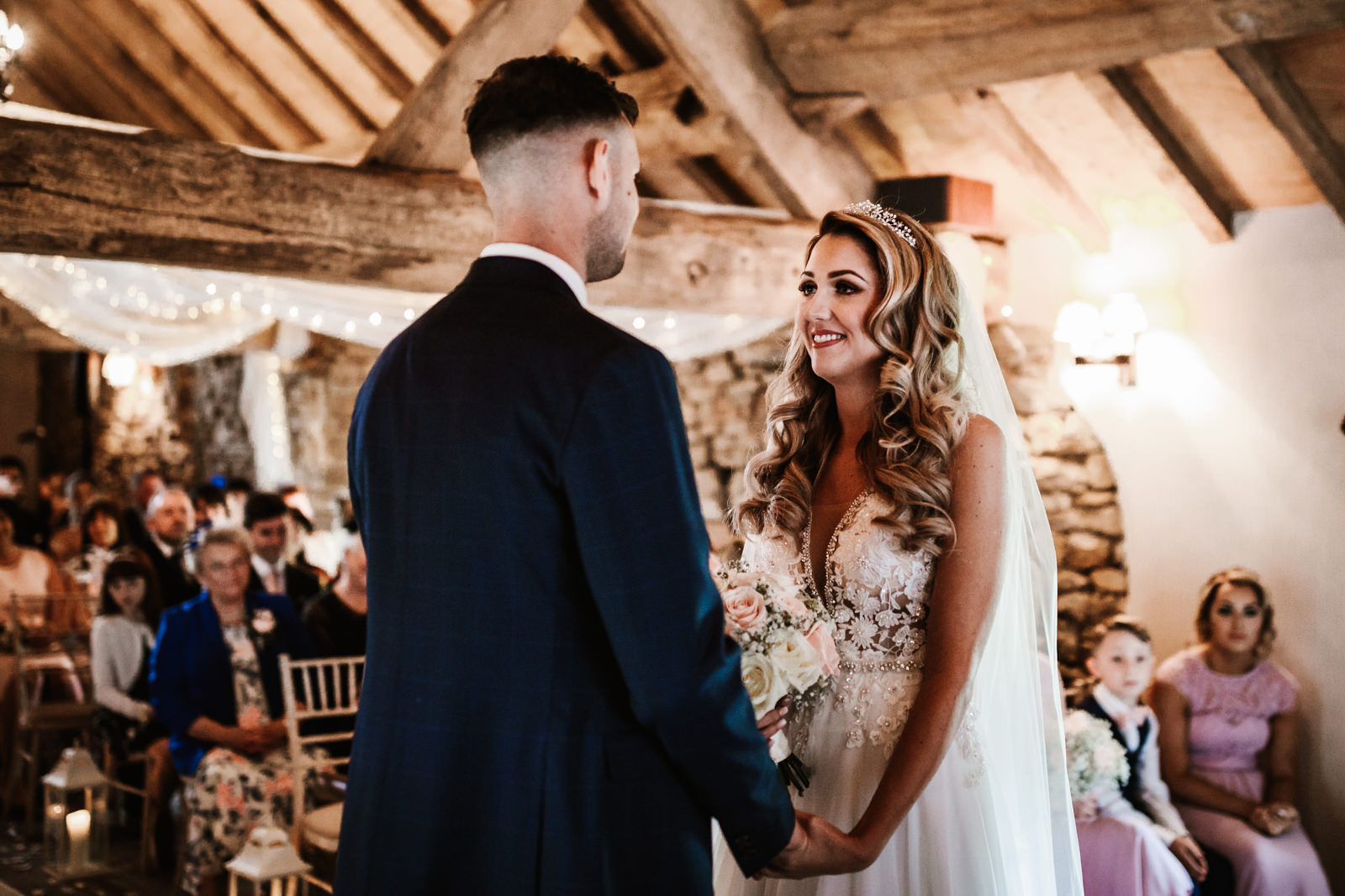 Bride and groom smiling at each other during the ceremony