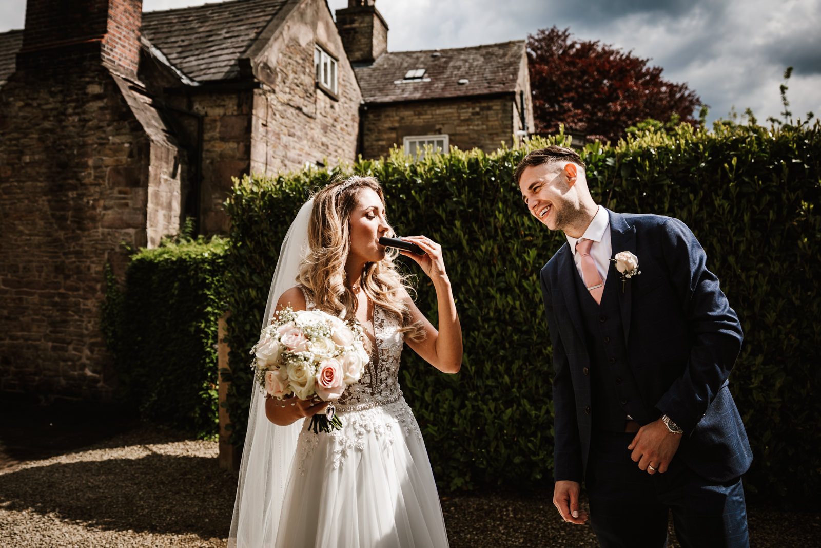Bride drinking from the hip flask