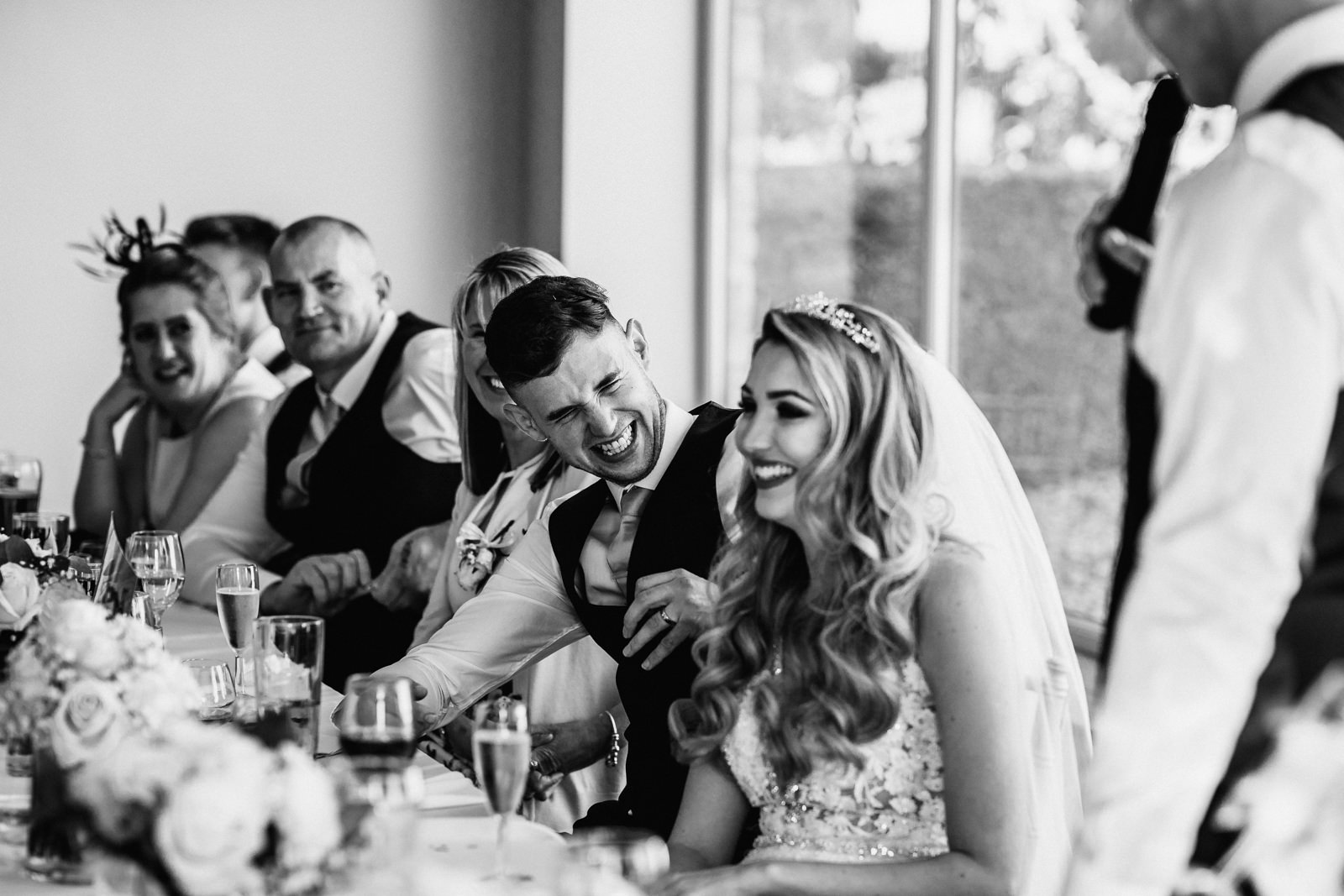 Groom laughing during speeches