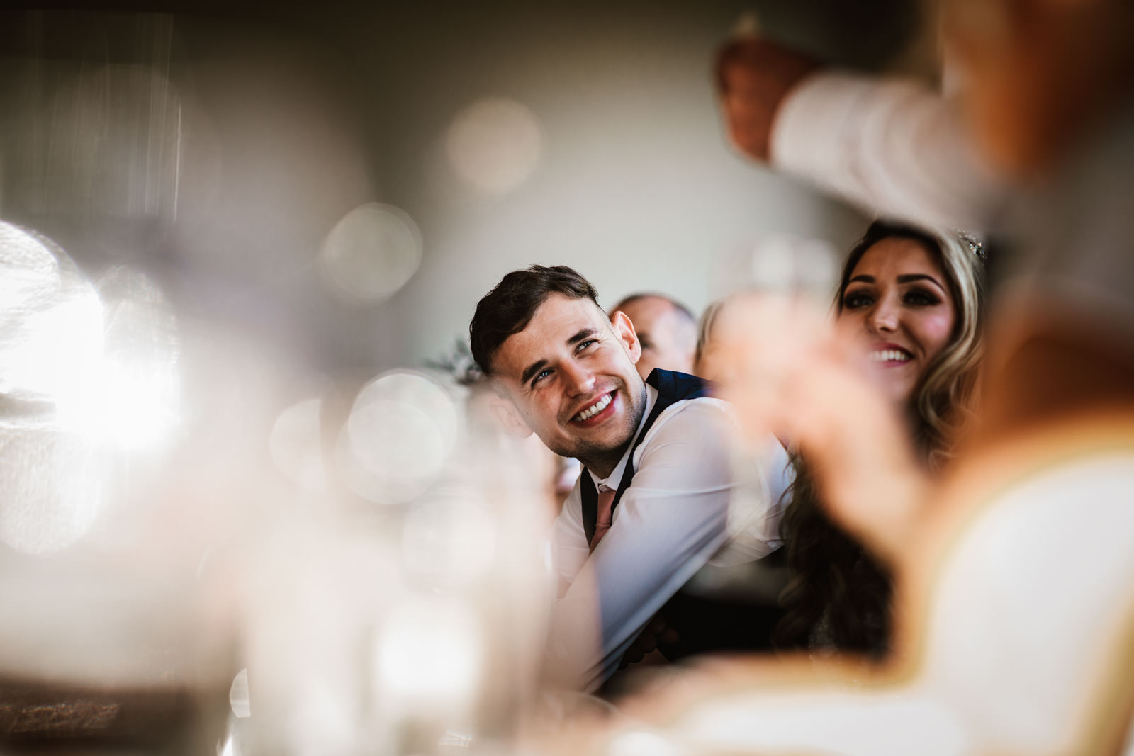 Groom smiling at the father of the bride