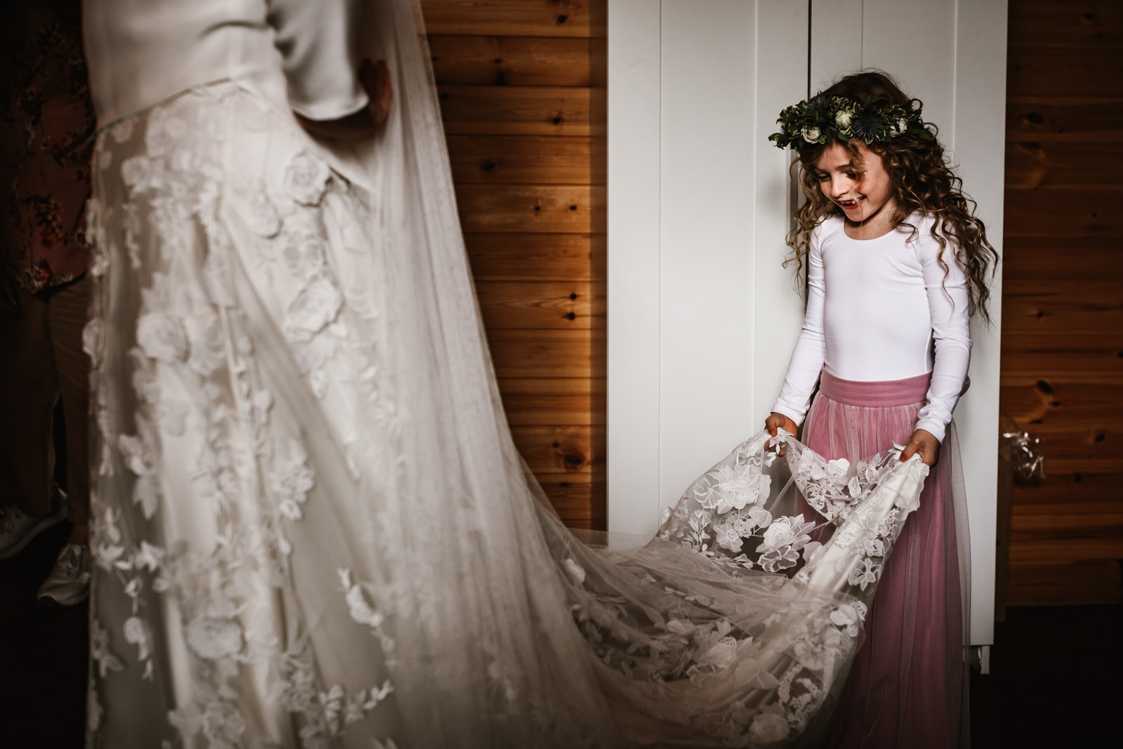 Little girl holding her mummys wedding dress