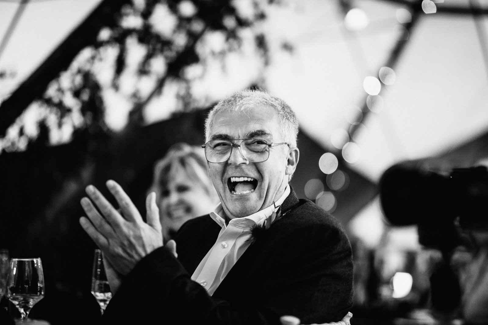 father of the groom laughing during the speeches