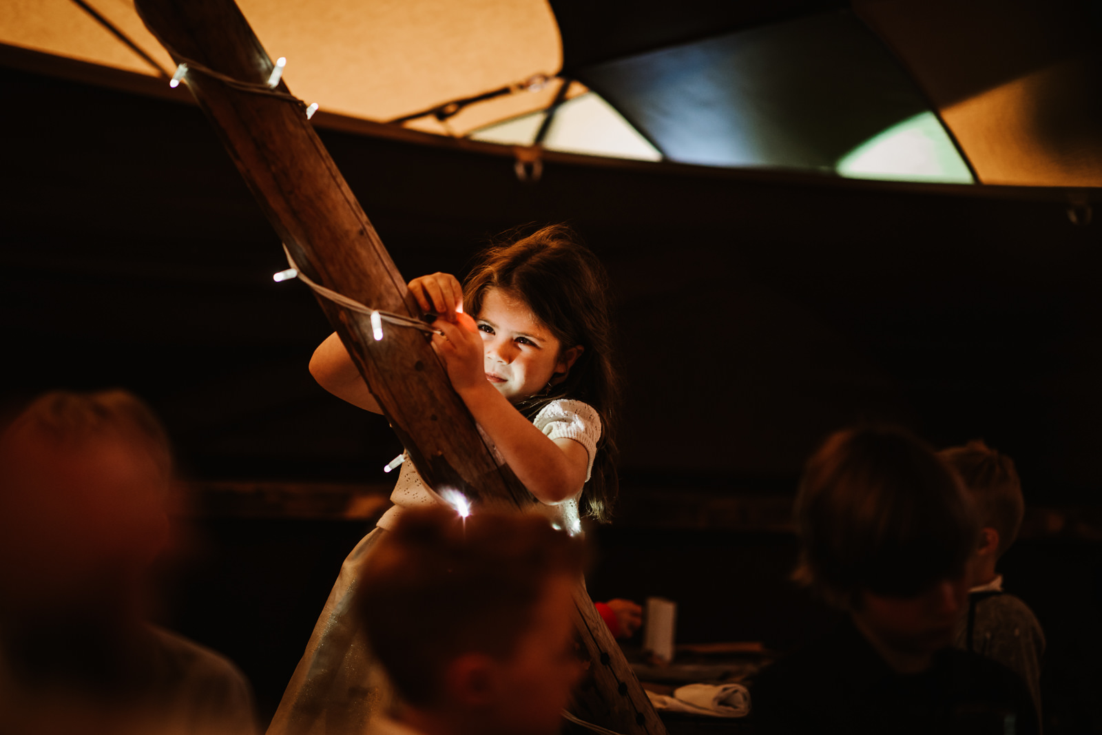 Girl playing with the tipi lights