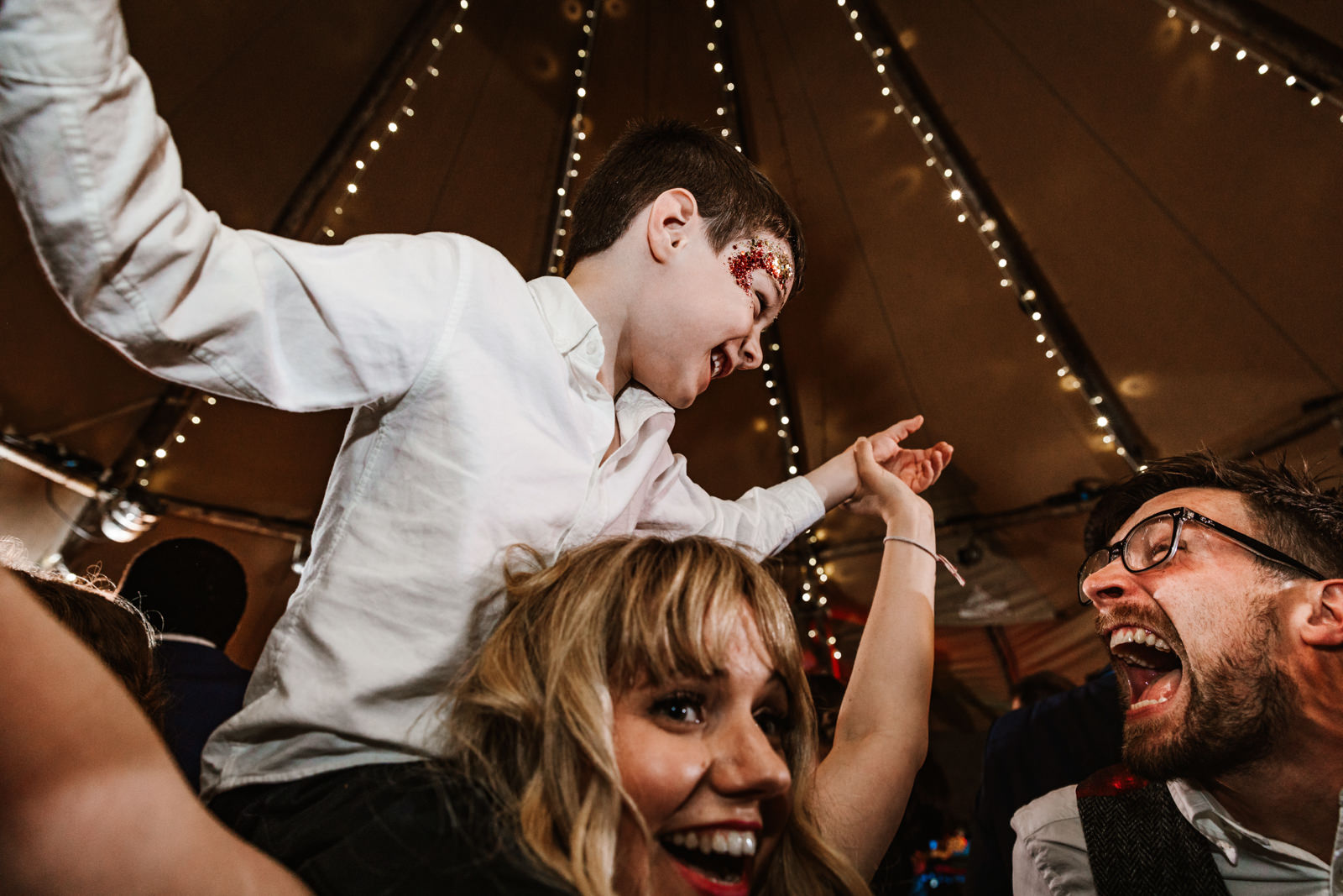 little boy and groom laughing together
