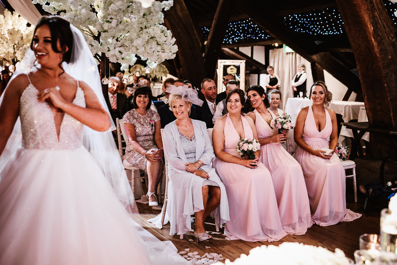 Bridesmaids smiling during the wedding ceremony
