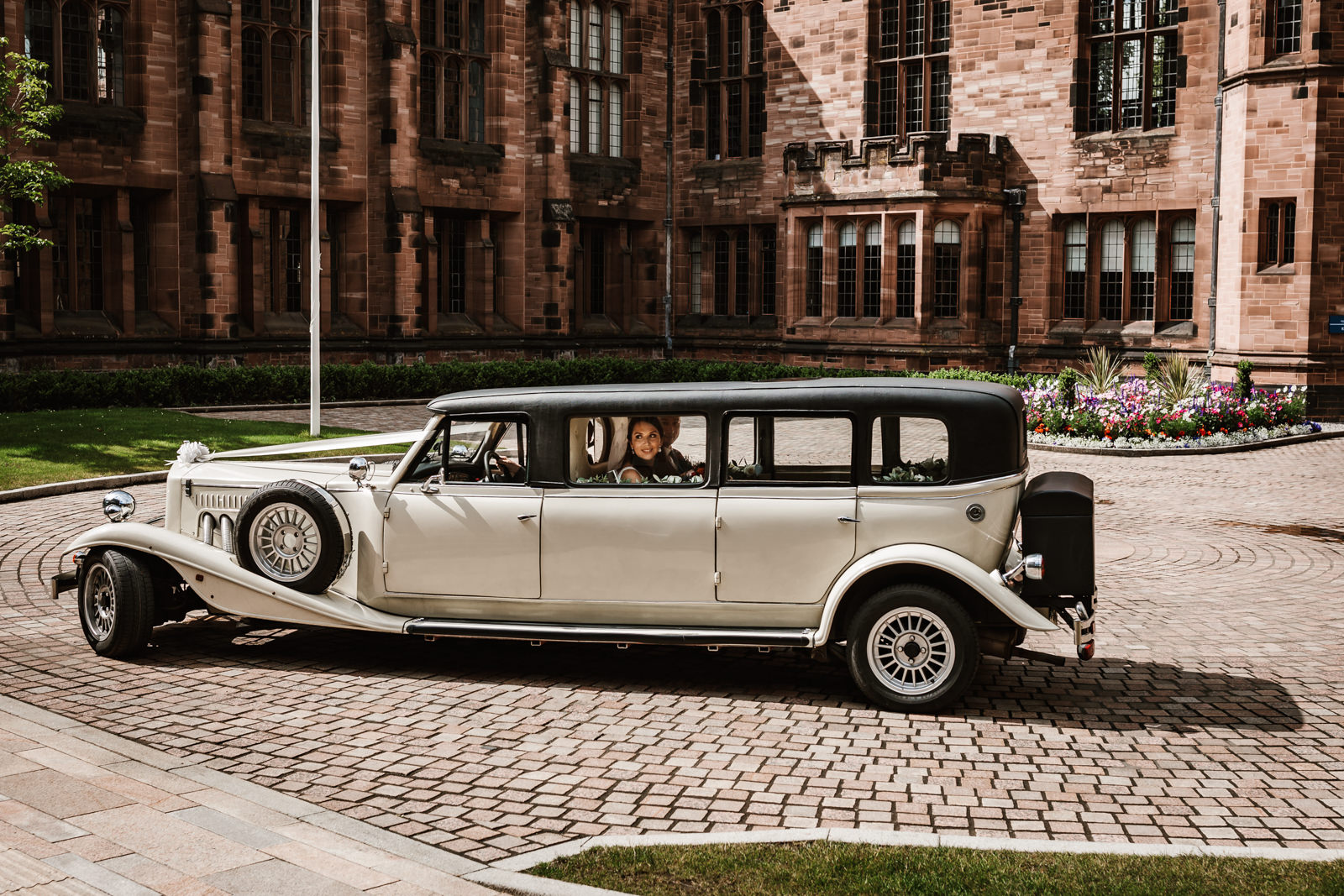 Bride and groom arriving in wedding car