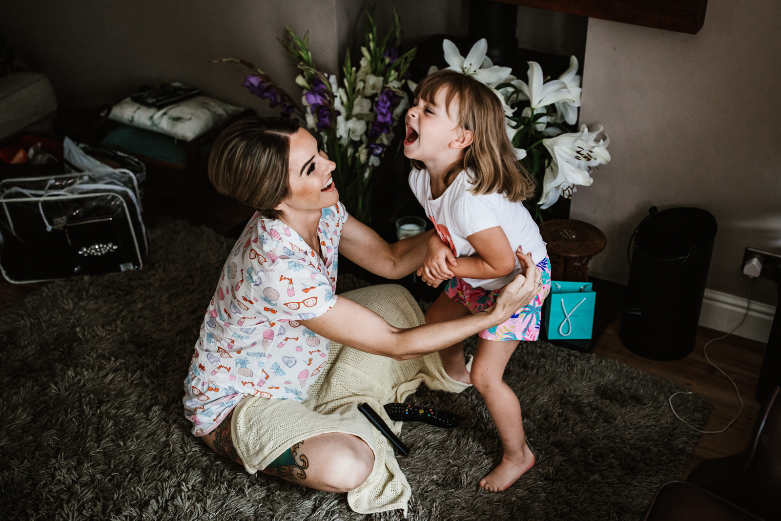 Lester Meadows Tipi Wedding Cheshire 3 Flower girl playing with bridesmaid