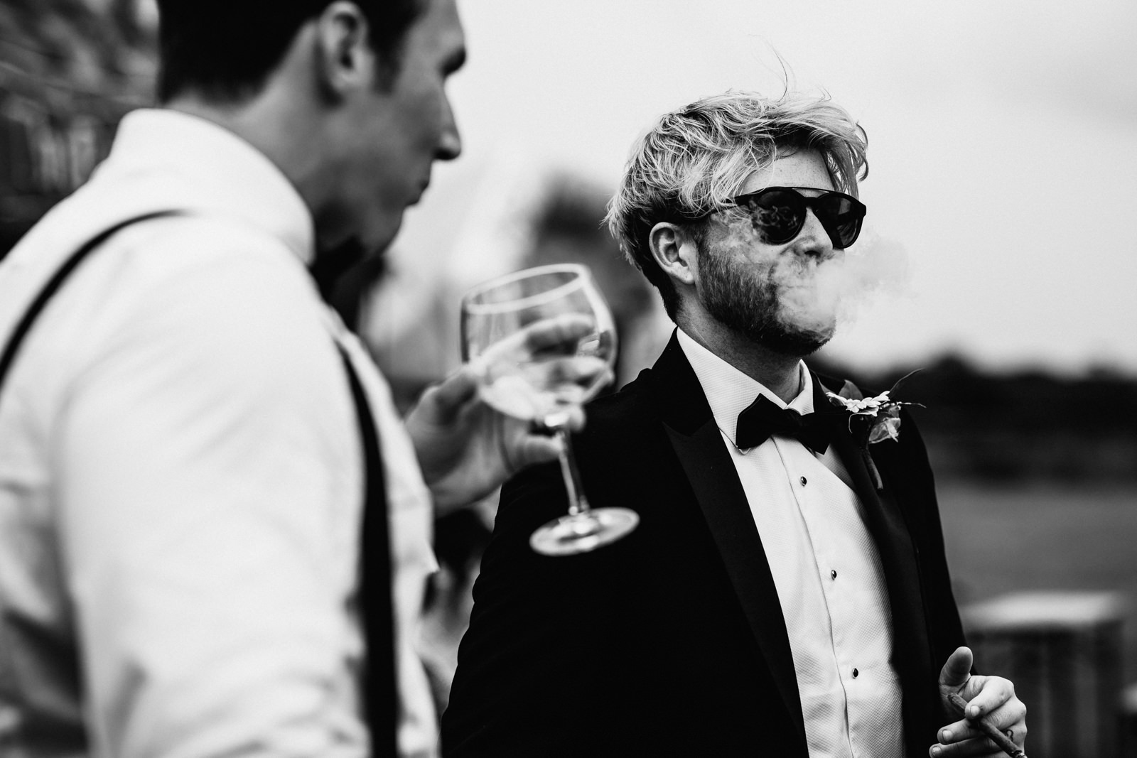 Lester Meadows Tipi Wedding Cheshire 41 Wedding guest smoking cigar