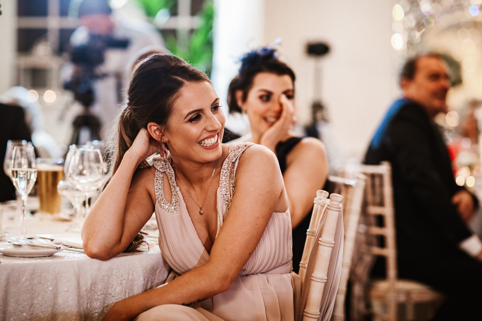 Bridesmaid laughing during speeches