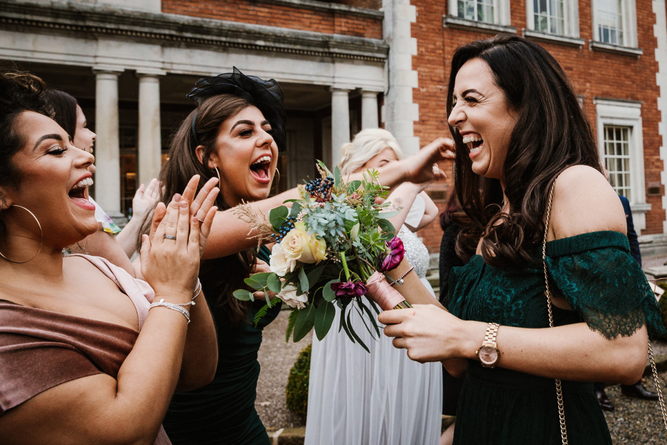 Brides friend catches flowers
