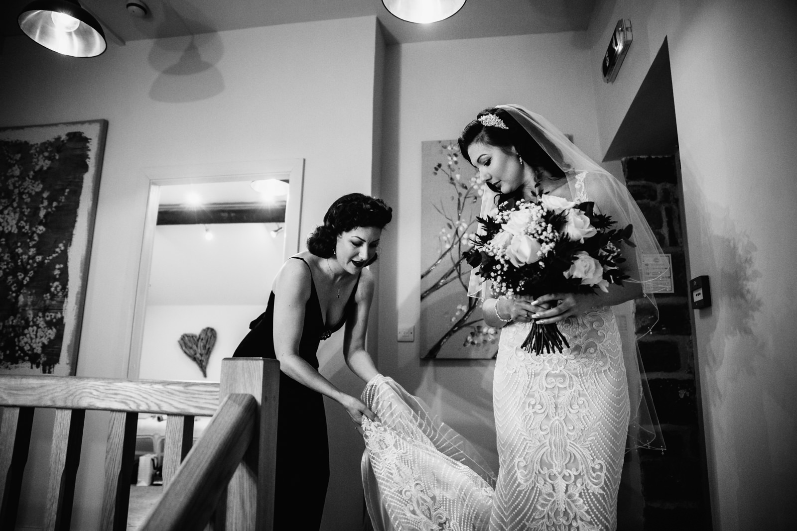 Bride getting help with her wedding dress at The Ashes Barns
