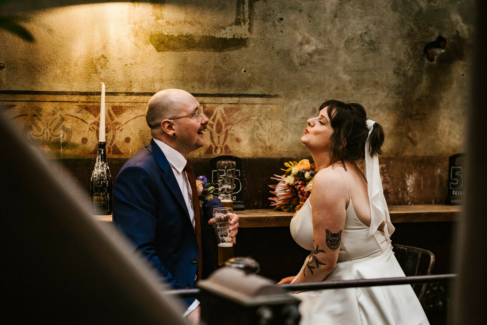 Bride blowing a kiss at Holmes Mill