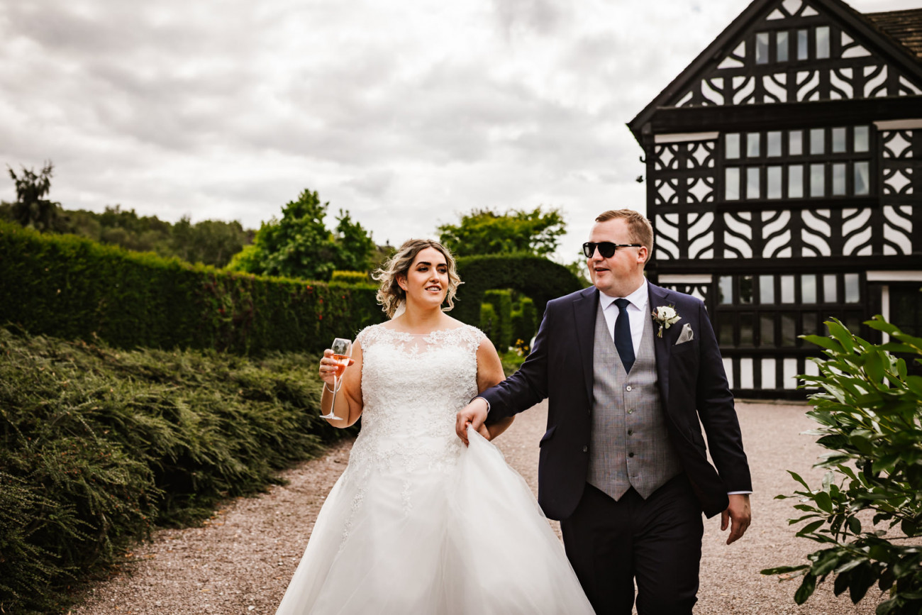 Bride and groom walking around The Holford estate