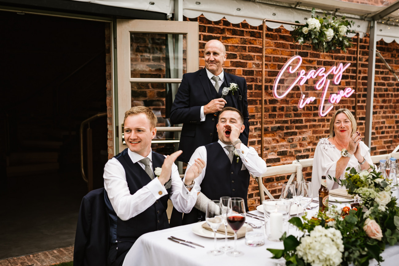 Wedding guests cheer in the bride and groom