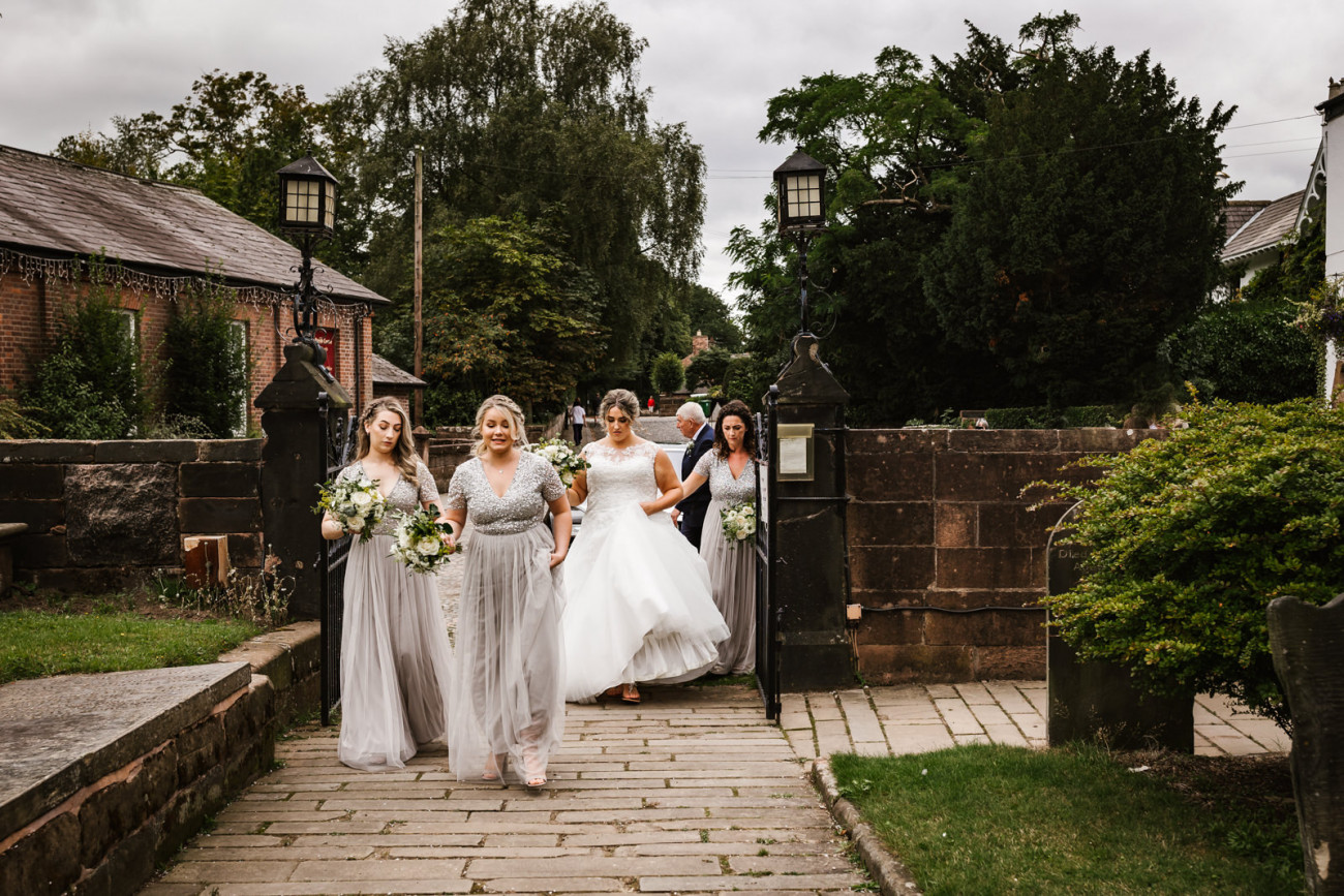 Bride arrives at church with bridesmaids