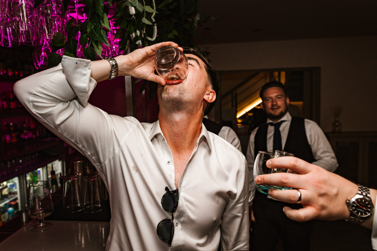 wedding guest having a shot
