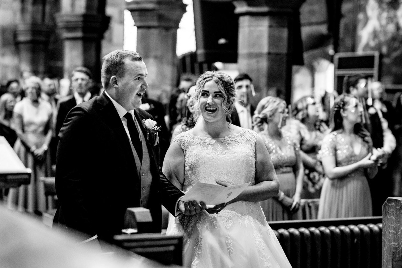 Bride and groom singing in church