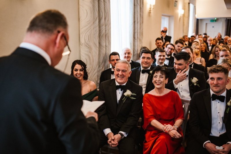 Wedding guests laughing during a reading