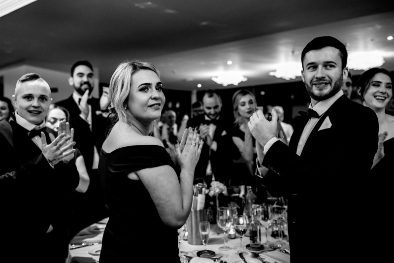 Wedding guests clapping for the new mr and mrs