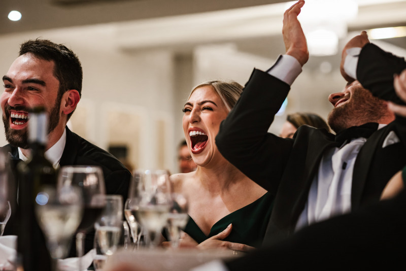 Bridesmaid laughing during the speeches