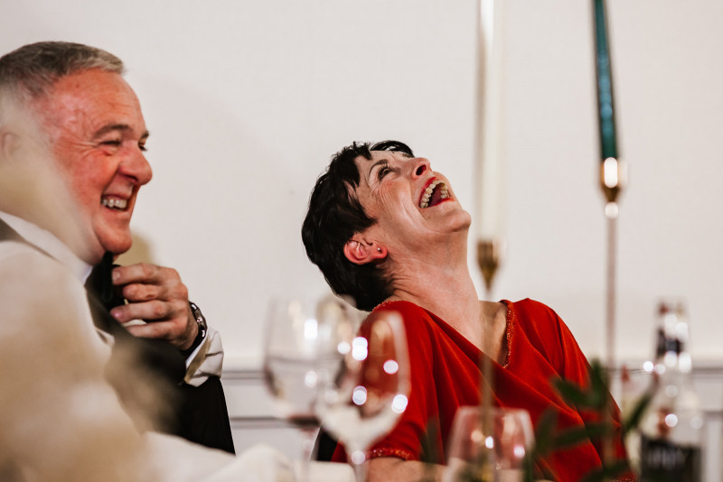 Mother of the groom laughing during speeches