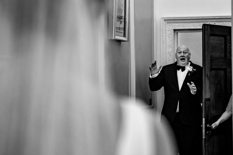 Father of the bride looking at his daughter for the first time in her wedding dress