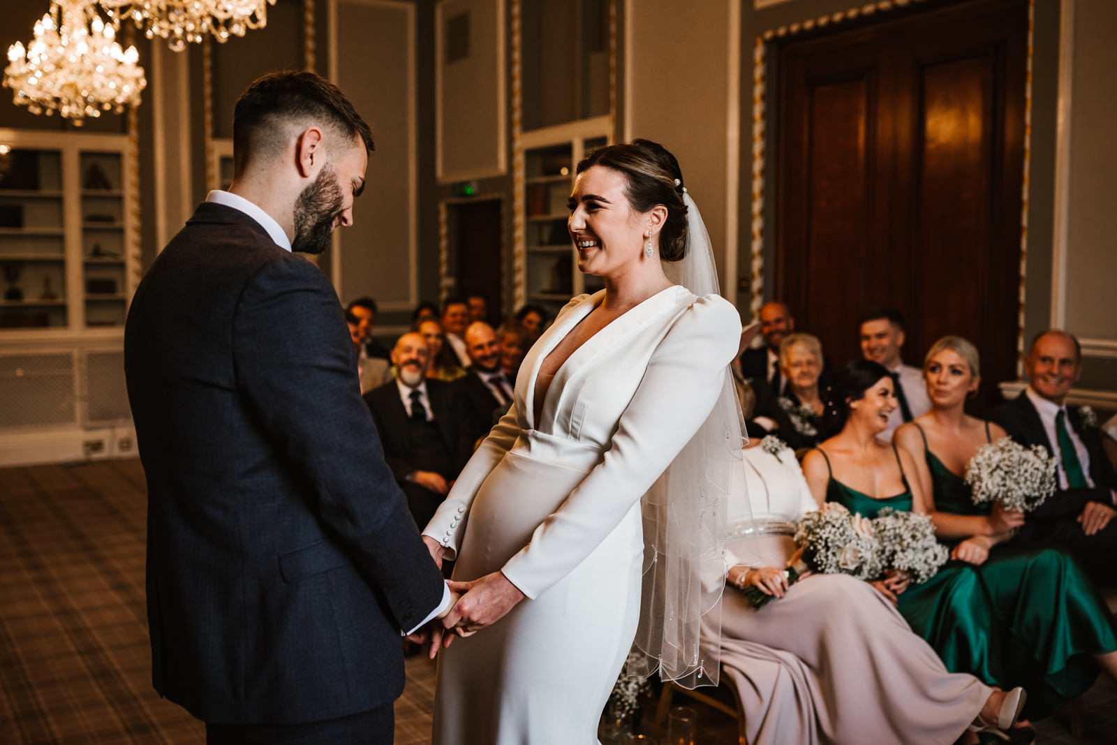 Bride laughing with her husband to be during the ceremony at manchester hall