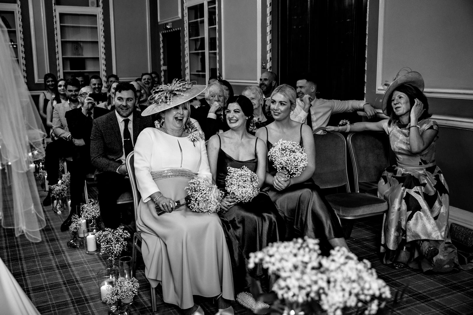 Mum and bridesmaids laughing during the ceremony