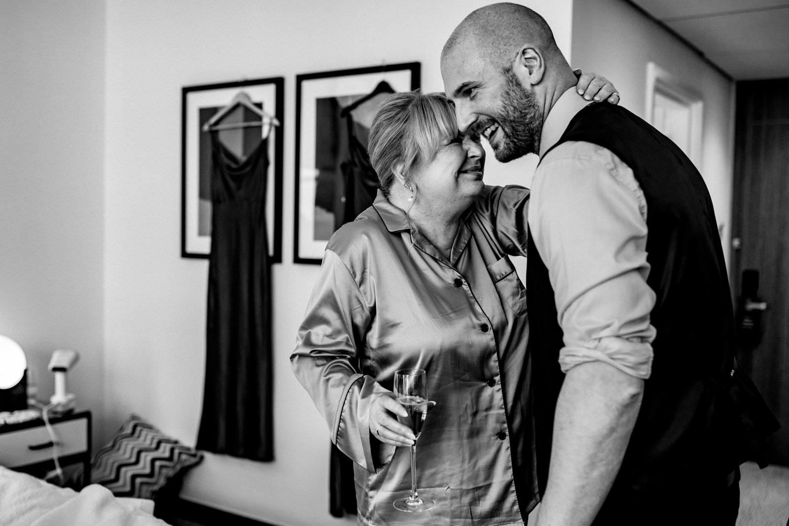 Mother of the bride hugging her son