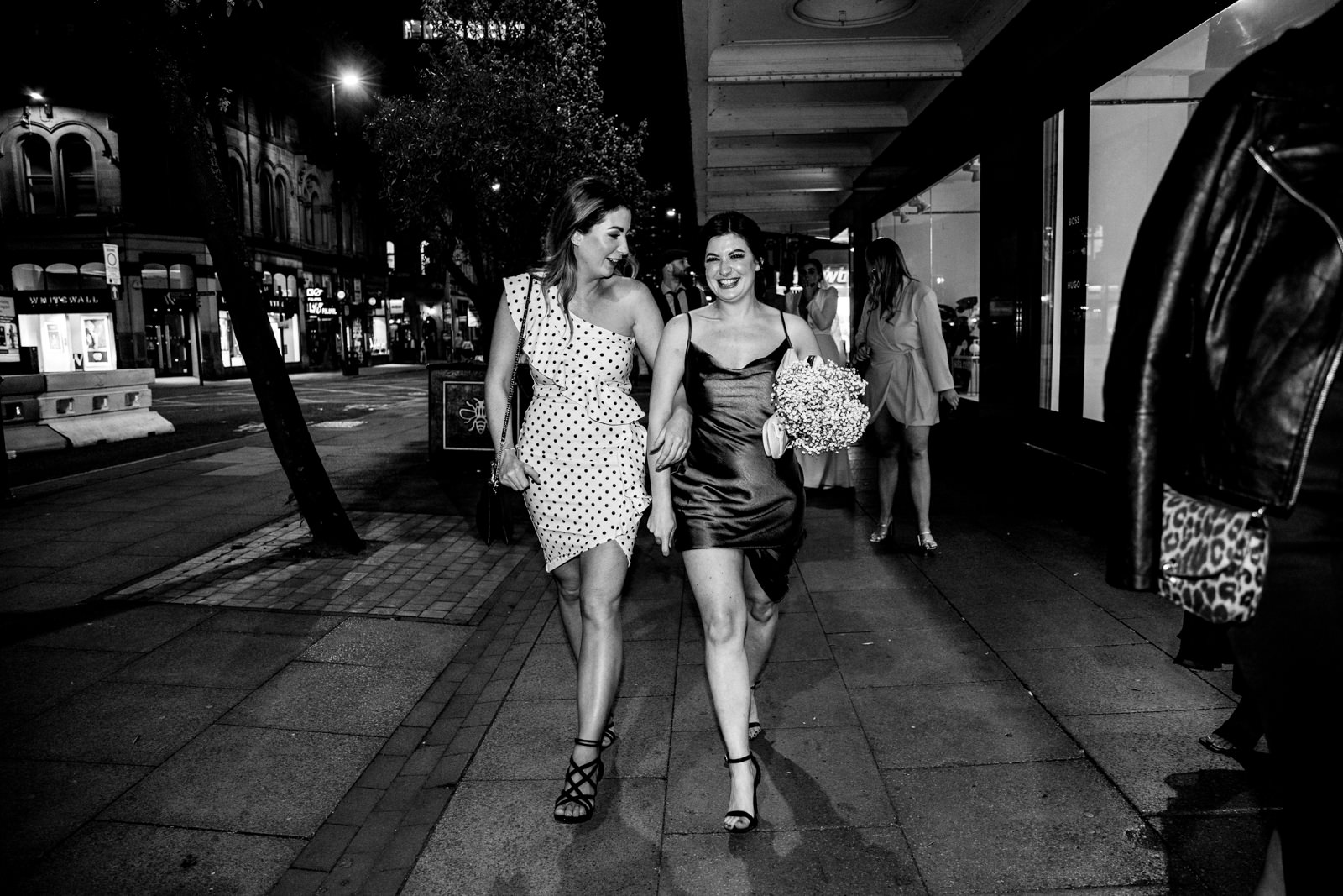 Wedding party walking through manchester