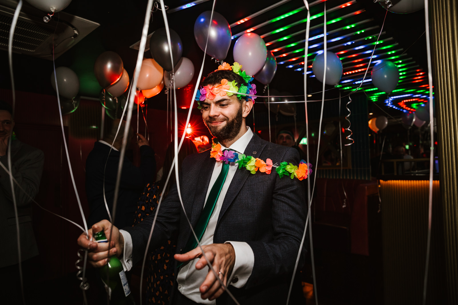 Groom wearing flowers on dance floor