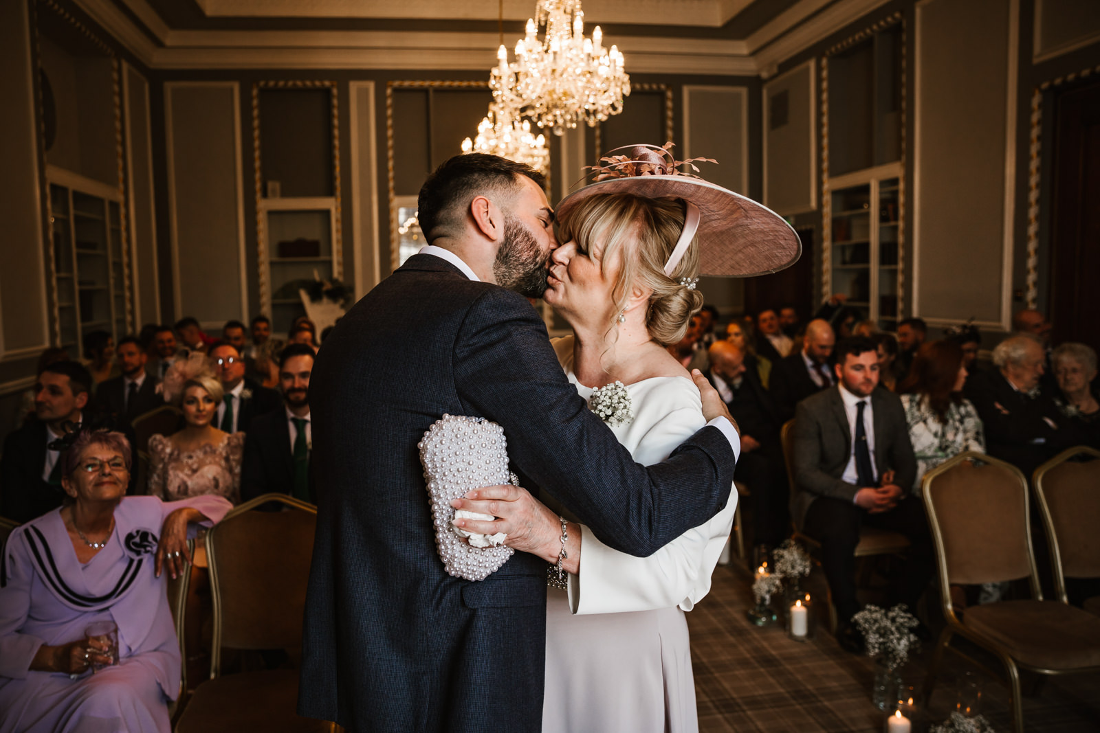 Brides mum kissing the groom