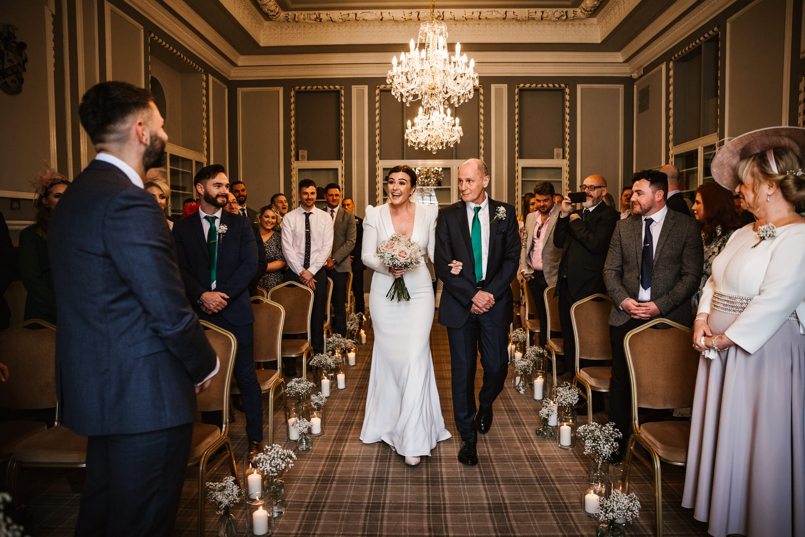 Bride walking down the aisle with her father at Manchester Hall
