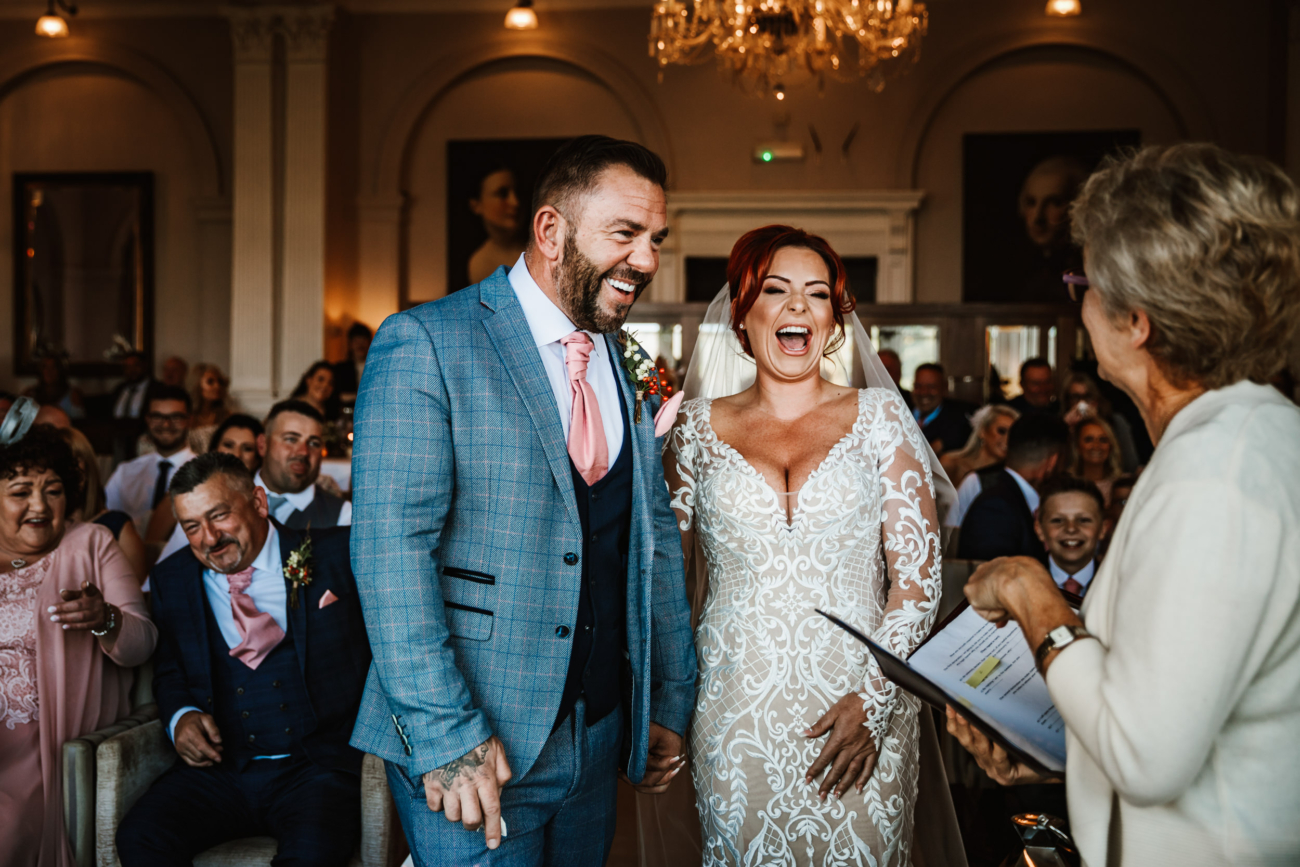 Bride and groom laughing during the ceremony 