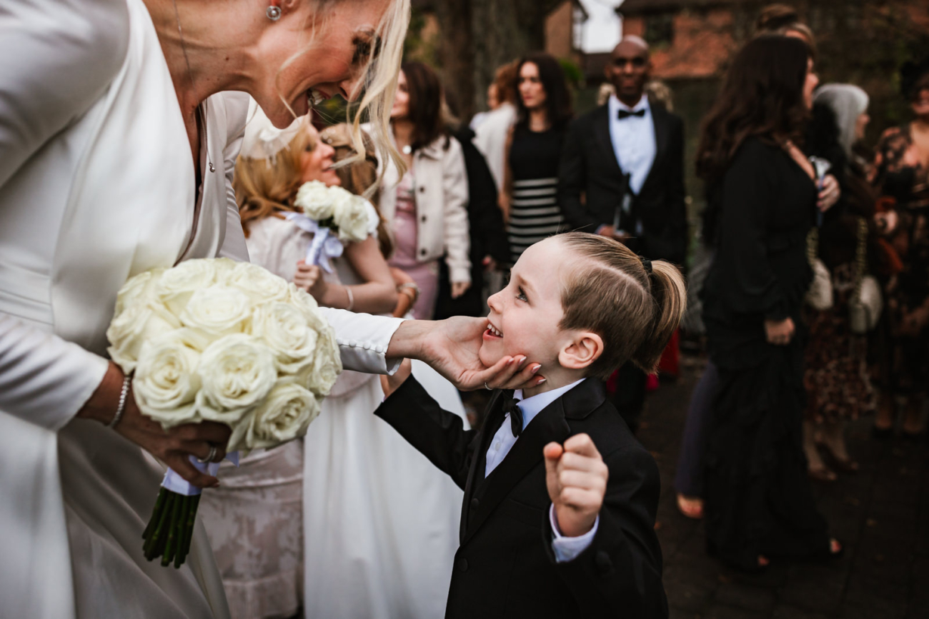 Bride holding her sons face