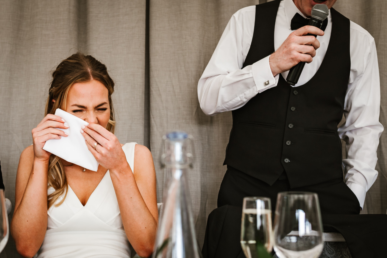 bride laughing during speeches