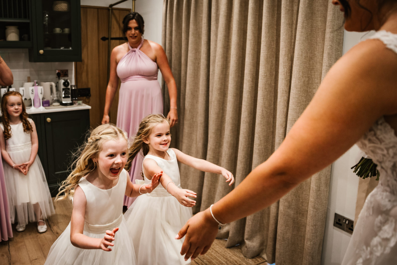 Rylands Farmhouse Wedding 12 Brides little girls running towards her