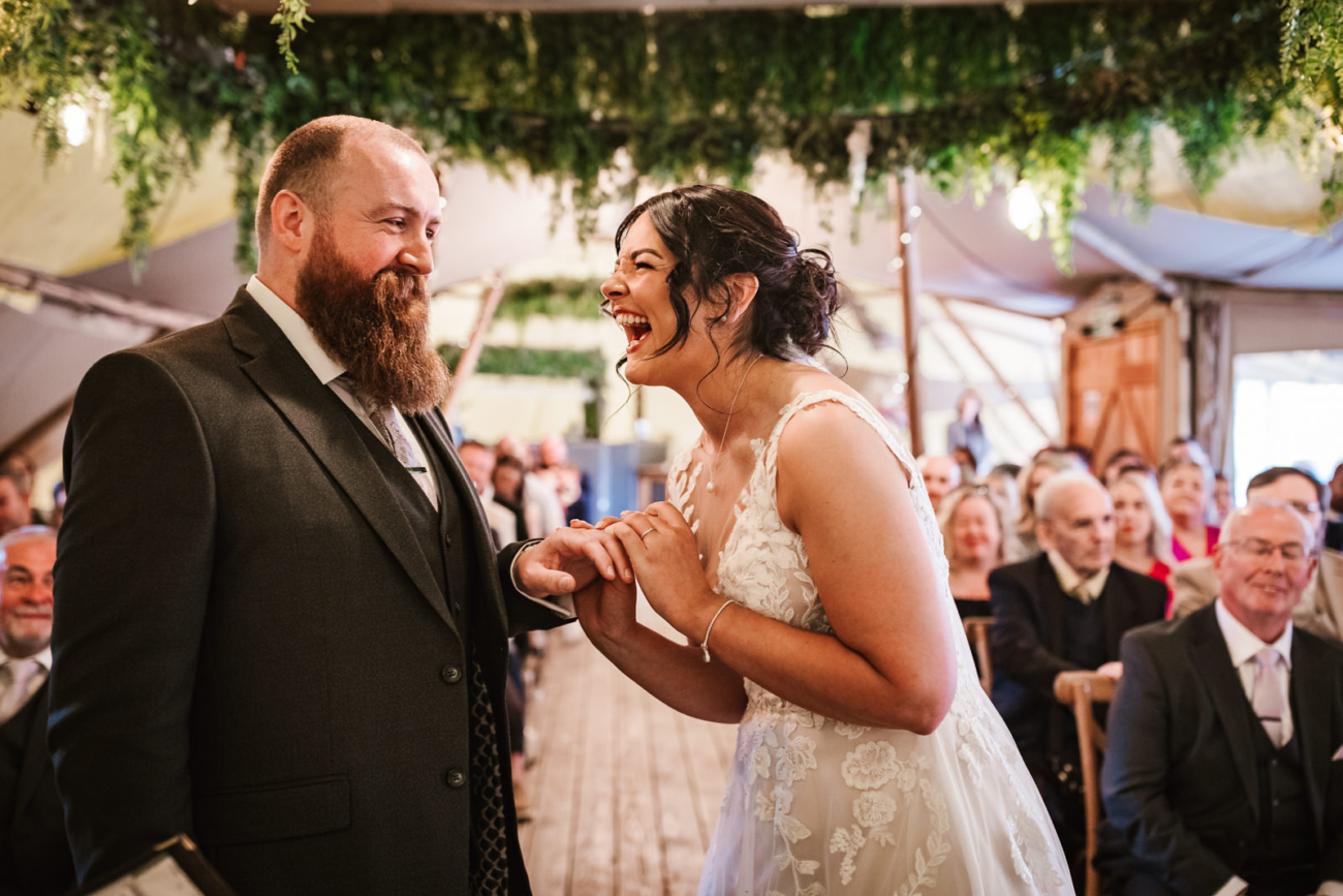 Rylands Farmhouse Wedding 18 Bride and groom exchanging rings