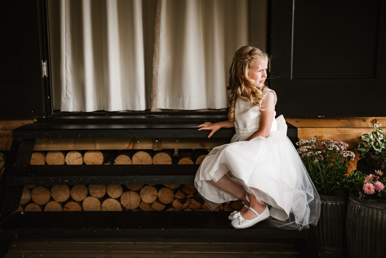 Rylands Farmhouse Wedding 8 Flower girl sat on step