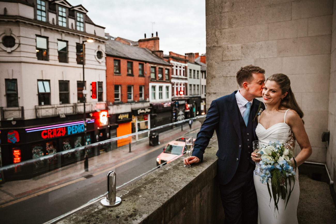 Bride and groom on the balcony at Manchester Hall