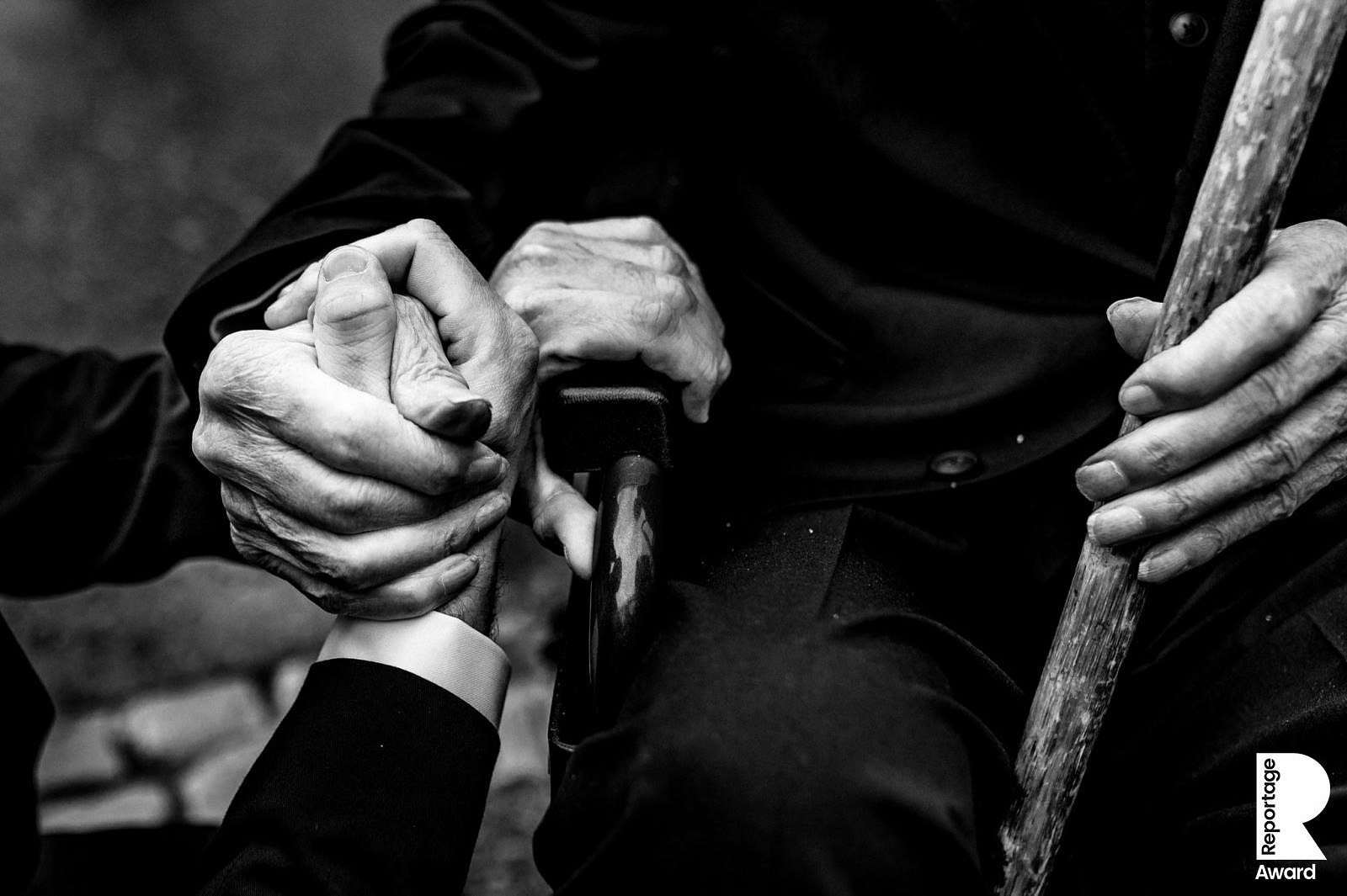 Dad holding his grandfather's hand at a wedding at The Ashes Wedding Barns